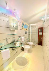 a bathroom with a sink and a toilet at The Dream - Seafront Loft in Giardini Naxos