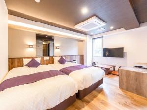 Postel nebo postele na pokoji v ubytování LiVEMAX RESORT Kusatsu Onsen