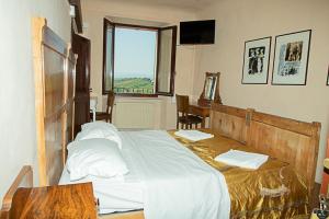 Postel nebo postele na pokoji v ubytování casa di Faustina (albergo diffuso) + 12 fotografií