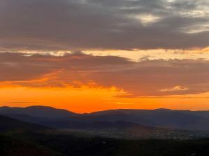 a sunset in the mountains with the sun setting at LA GASSINIÈRE in Gassin