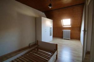 een lege kamer met een bed in een kamer met een raam bij Maison de 5 chambres avec wifi a Guebwiller in Guebwiller