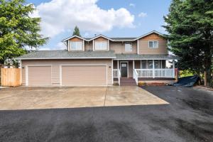 a house with a large driveway in front of it at Travelers Getaway in Vancouver
