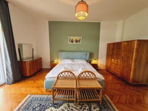 a bedroom with a bed and two chairs in it at Vila Gorenka in Bled