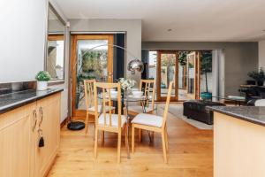 a kitchen and dining room with a table and chairs at The Herringbone - 3 Bed with Parking, Pet Friendly in Henley on Thames
