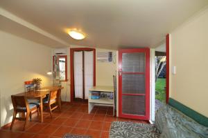 a kitchen with a table and a red refrigerator at The Berry Farm Retreat in Hastings