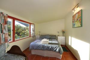 a bedroom with a bed and a window at The Berry Farm Retreat in Hastings