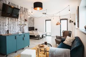 Televízia a/alebo spoločenská miestnosť v ubytovaní Joy Aparthotel Keilberg