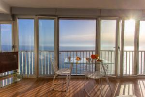 a room with a balcony with a table and chairs at Cullera Panoramic Sea Views Apartment in Cullera