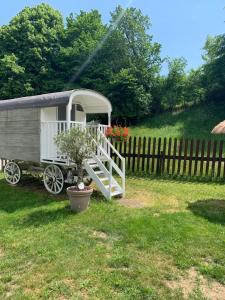 a trailer in a yard with a fence at My little sweet home in Colombe