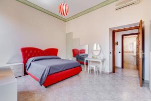 una camera con letto rosso, tavolo e specchio di Navona View a Roma