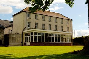a large brick building with a large window at Ashbrook Arms Townhouse and Restaurant in Durrow