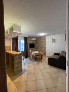 a living room and dining room with a couch and a table at Apartments Vesna in Tivat