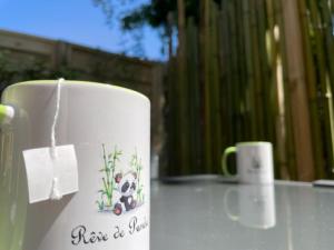 a white coffee mug with a teddy bear on it at La cabane du Panda in Abrest