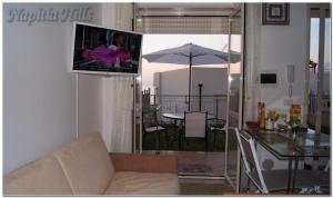 a living room with a couch and a table with an umbrella at Apartment Napitia Hills in Pizzo