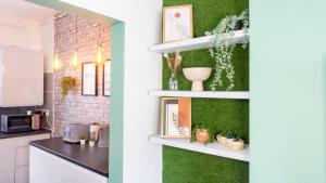 a kitchen with a green wall and a kitchen with a counter at Air Host and Stay - Bevington house modern chic home sleeps 8 in Liverpool