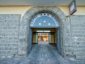 an entrance to a building with an archway at Hotel Silverado in Aversa +16 photos