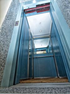 an elevator in a building with a glass door at Hotel Silverado in Aversa