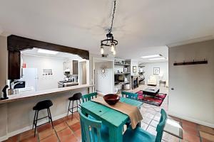 a kitchen and dining room with a table and chairs at Plazadise in Santa Fe