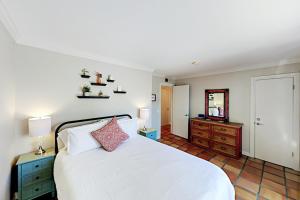 een slaapkamer met een bed, een dressoir en een spiegel bij Plazadise in Santa Fe