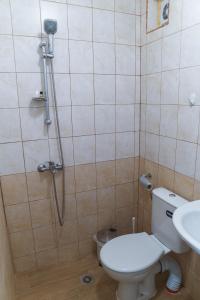 a bathroom with a shower and a toilet and a sink at Guest House Nevena in Shabla +11 photos