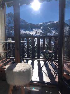 a white chair sitting on a balcony with a view at Casa Calpurnia Cerler in Cerler