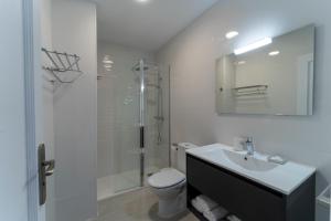 a bathroom with a toilet and a sink and a shower at Comfortable Apartment Los Cristianos. Free Wifi. in Arona +25 photos