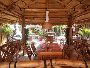 a wooden deck with a table and chairs at Le Moulin de Lily in Palaiseau