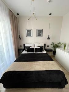 Postel nebo postele na pokoji v ubytování Sunset Resort APARTAMENT DZIESIĄTKA przy plaży