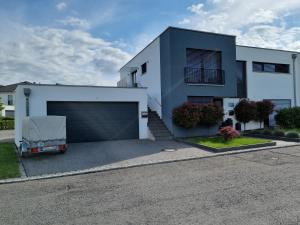 Ella's Lounge - besonders genießen في سينجين: سيارة متوقفة أمام مبنى فيه كراج