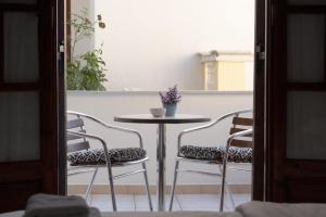una mesa con dos sillas y una mesa con una taza. en Pomelo Rooms en Párga