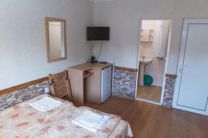 a small room with a bed and a bathroom at Guest House Nevena in Shabla