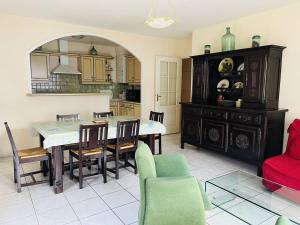 a kitchen and dining room with a table and chairs at Appartement Cambo-les-Bains, 3 pièces, 4 personnes - FR-1-495-18 in Cambo-les-Bains