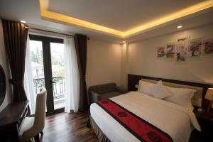 Postel nebo postele na pokoji v ubytování Sapa Wings Hotel