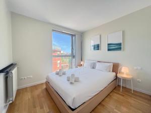 a bedroom with a large bed and a large window at Stay U-nique Apartments Degà Bahí in Barcelona