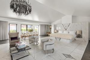 a bedroom with a large bed and a chandelier at The Mandrake in London