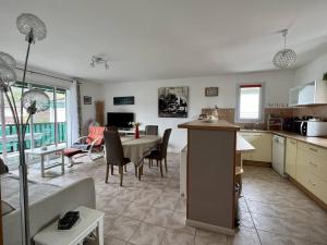 a kitchen and living room with a table and a dining room at Appartement Cambo-les-Bains, 2 pièces, 2 personnes - FR-1-495-58 in Cambo-les-Bains