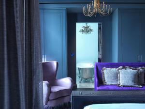 a room with a blue couch and a blue chair at The Mandrake in London