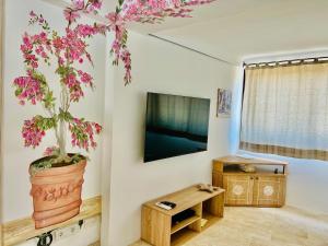 una sala de estar con una maceta en la pared en Villa Ibiscus, en Cannigione