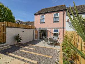 a home with a patio and a fence at Mermaid House in Weymouth