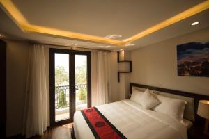 Postel nebo postele na pokoji v ubytování Sapa Wings Hotel