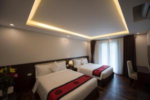 Postel nebo postele na pokoji v ubytování Sapa Wings Hotel
