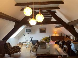 a living room with wooden ceilings and wooden beams at Charmante maison familiale avec cour fermée, proche randonnées et sites naturels - FR-1-489-277 in Arfeuilles