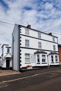 a white building on the side of a street at Delven House, Apartment 6 in Castle Donington