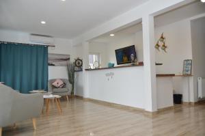 a living room with a couch and a table at Tecoma Rooms Mamaia in Mamaia Sat/Năvodari