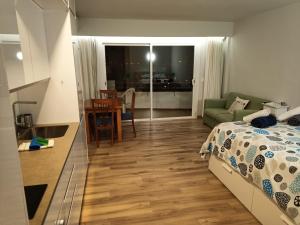 a bedroom with a bed and a kitchen and a table at The BEST Views in Alcúdia - 7th floor studio in Alcudia