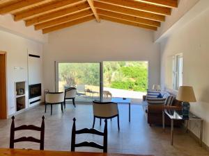 a living room with a couch and a table and chairs at Hortas de Baixo in Luz de Tavira