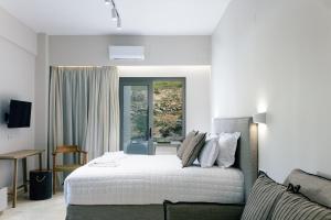 A bed or beds in a room at Ariadne Suites