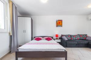 a bedroom with a bed and a couch at Apartments Maria in Dubrovnik +84 photos