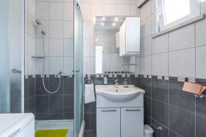 a bathroom with a sink and a shower at Apartments Maria in Dubrovnik