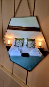 Antlers Bed and Breakfast في Abbots Bromley: مرآة تعكس سرير في الغرفة
